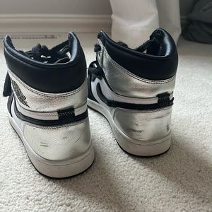 black, white, and silver air jordan 1